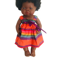 Doll dressed in Rainbow Stripe Bow Dress